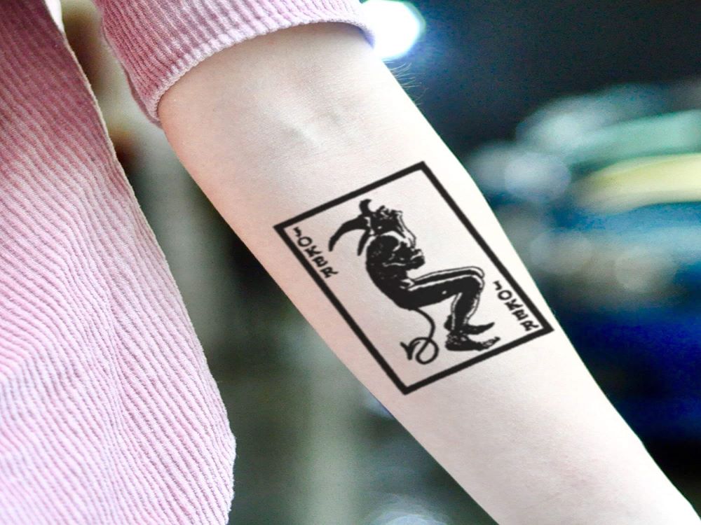 Playing cards tattoo on the inner forearm